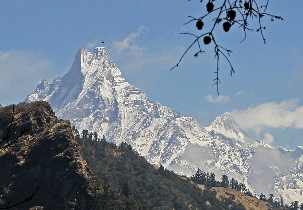 Machapuchare above forested ridges, seen from the Ghorepani to Tadapani trail